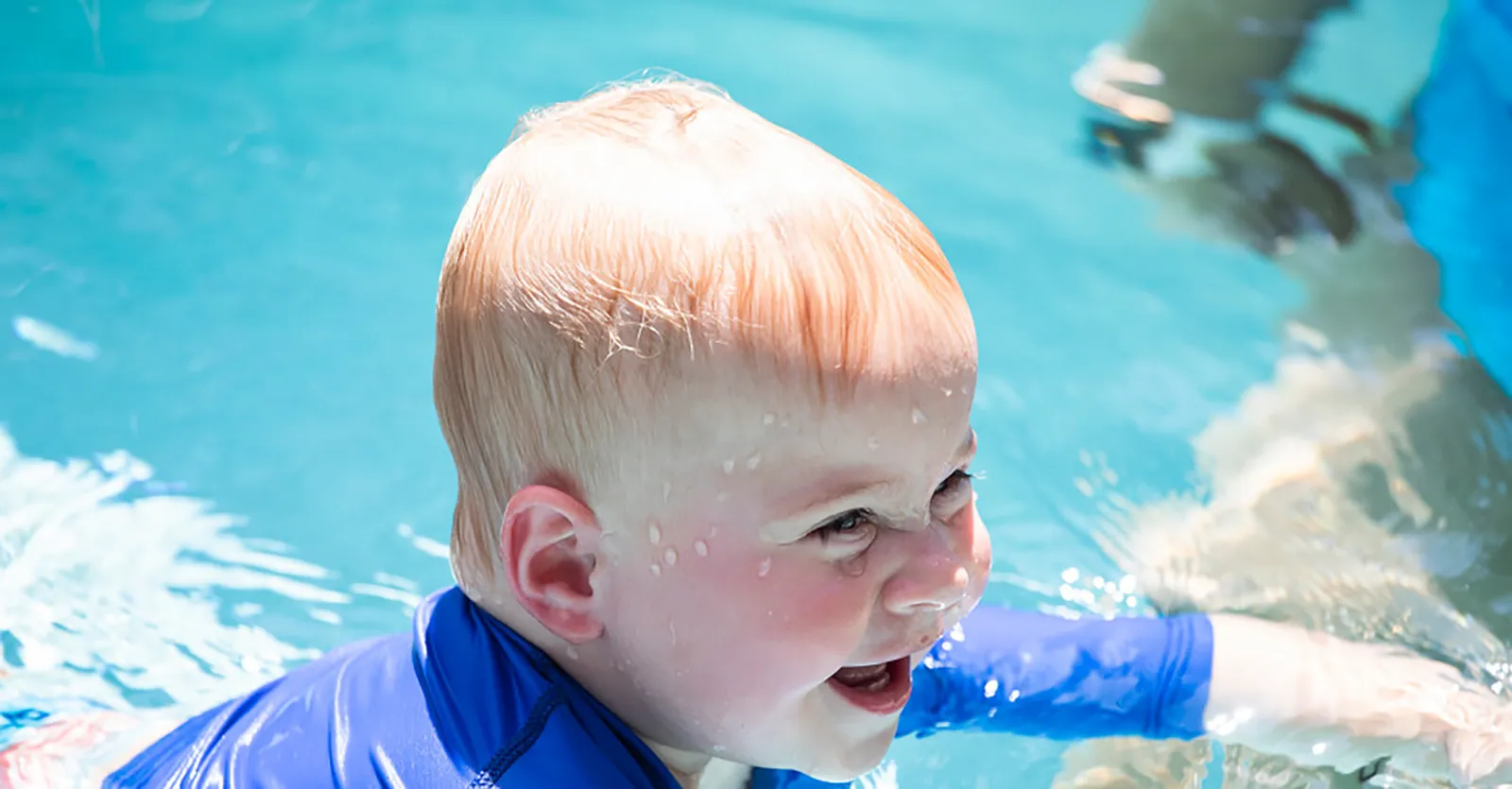Boy in Pool Toddler smiling in pool during an ISR lesson