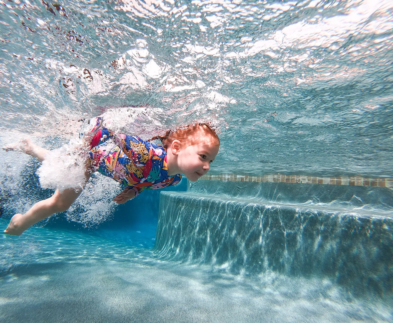 Child Swimming Toddler swimming in pool during an ISR lesson